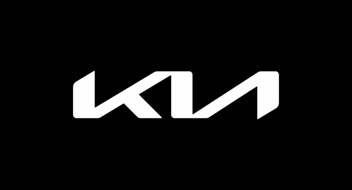 An image of the newest Kia logo on a black backdrop with white font