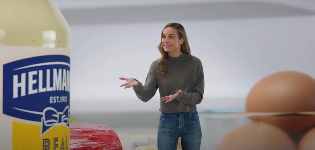 Brie Larson stands beside a jar of Hellmann's mayo in their newest Super Bowl event commercial
