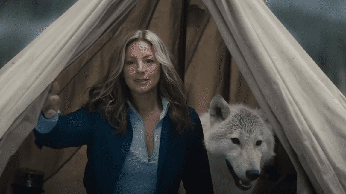Sara McLacklan stands beside in a wolf in a tent, featured in Busch's 2023 Super Bowl commercial